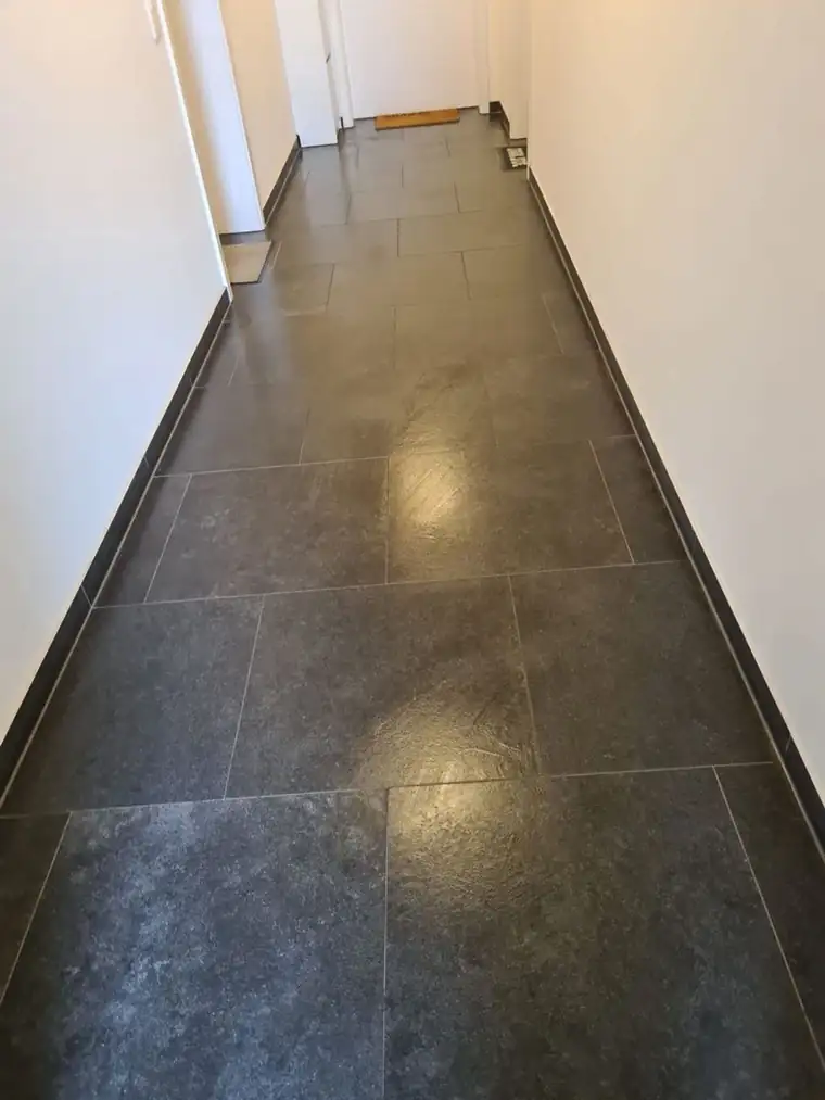 Gereinigter Flur mit dunklem Fliesenboden